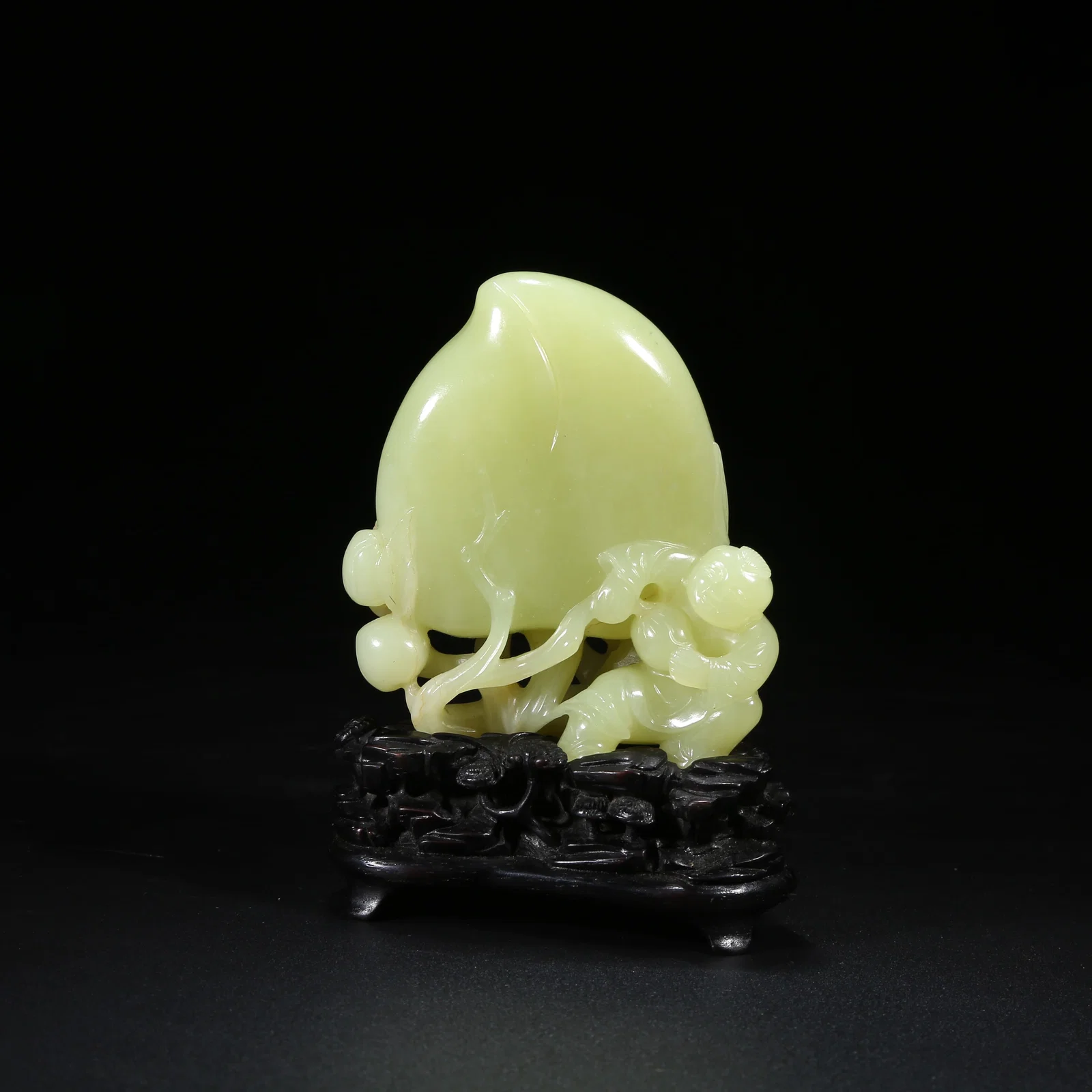 A YELLOW JADE FIGURINE OF CHILD OFFERING LONGEVITY