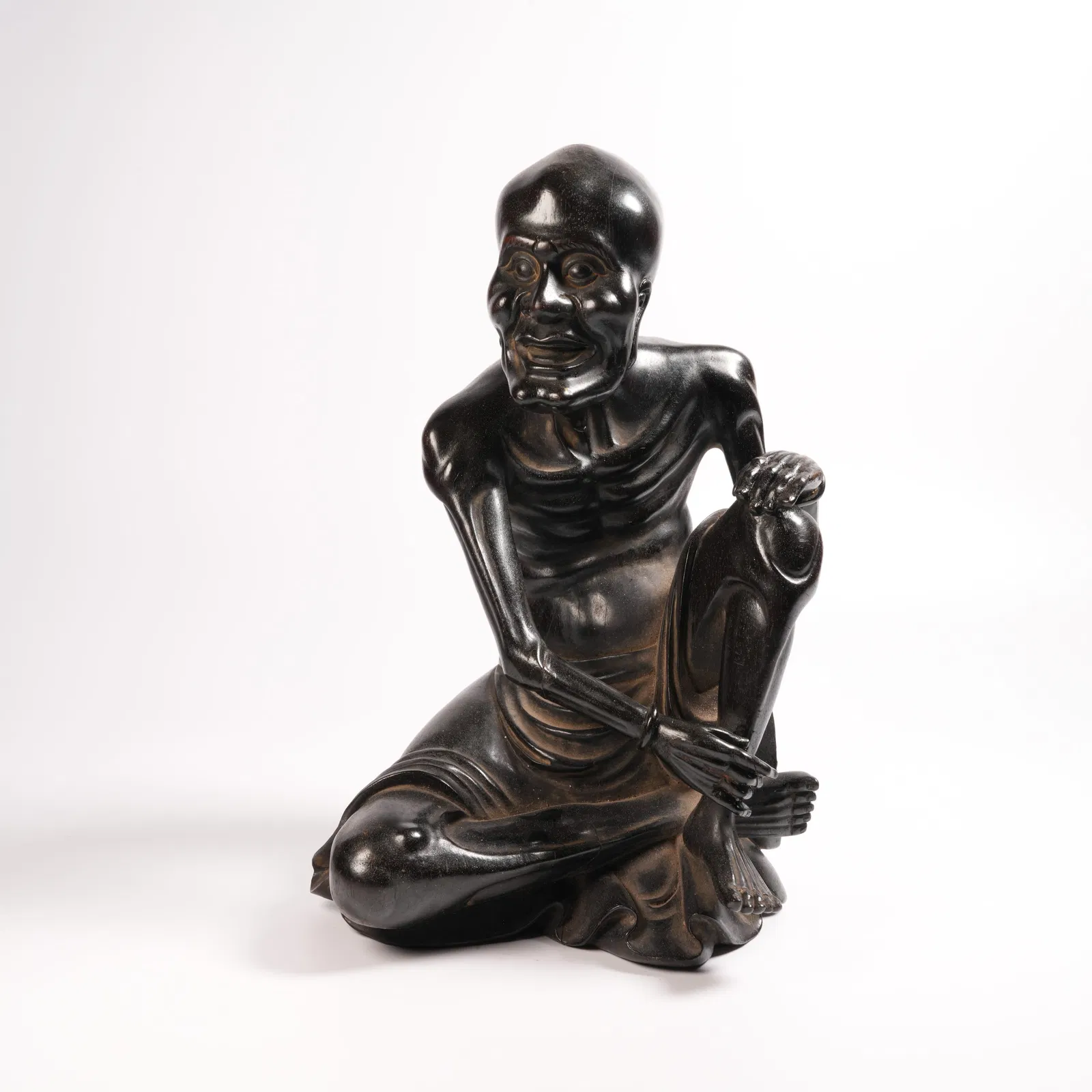 A ZITAN SLIM-BODIED ARHAT FIGURINE
