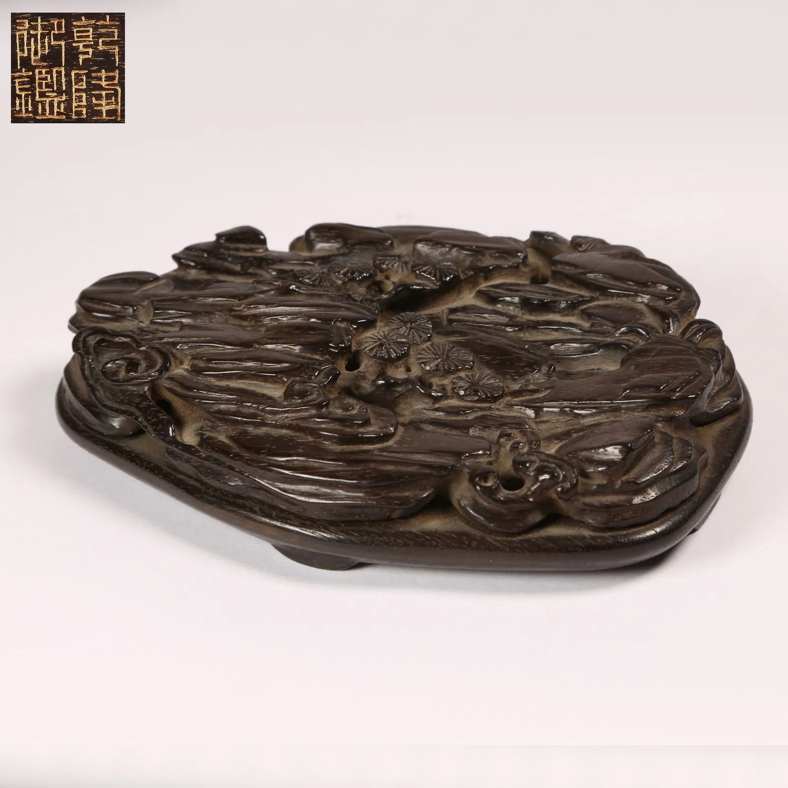 A ZITAN WOOD BASE WITH PINE TREE MOTIF
