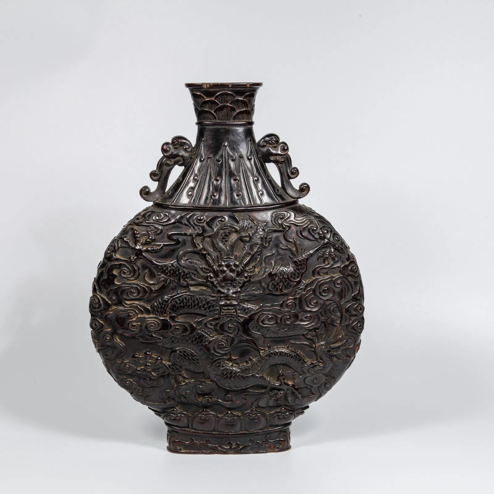 A ZITAN WOOD CARVED CLOUD AND DRAGON PATTERN DOUBLE-HANDLED BOTTLE