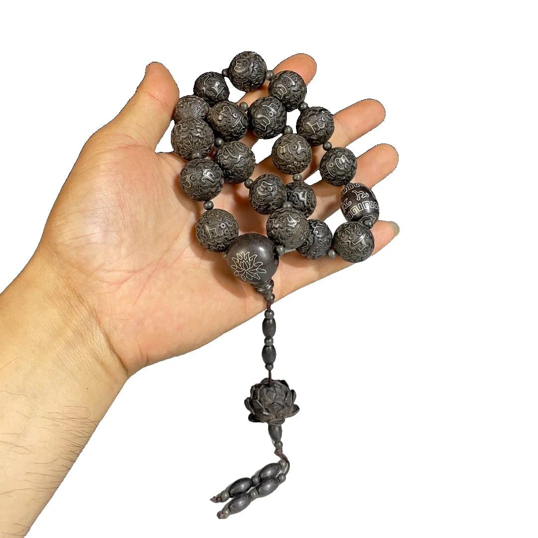 Agarwood hand-held fan with silver wire inlay.