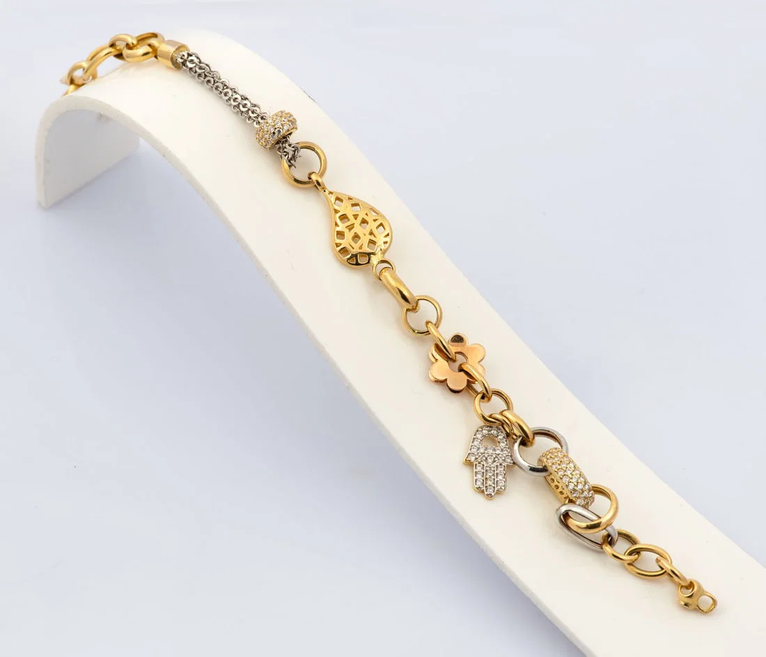 An 18K Three Tone Gold and Zirconia Designer Charms Bracelet