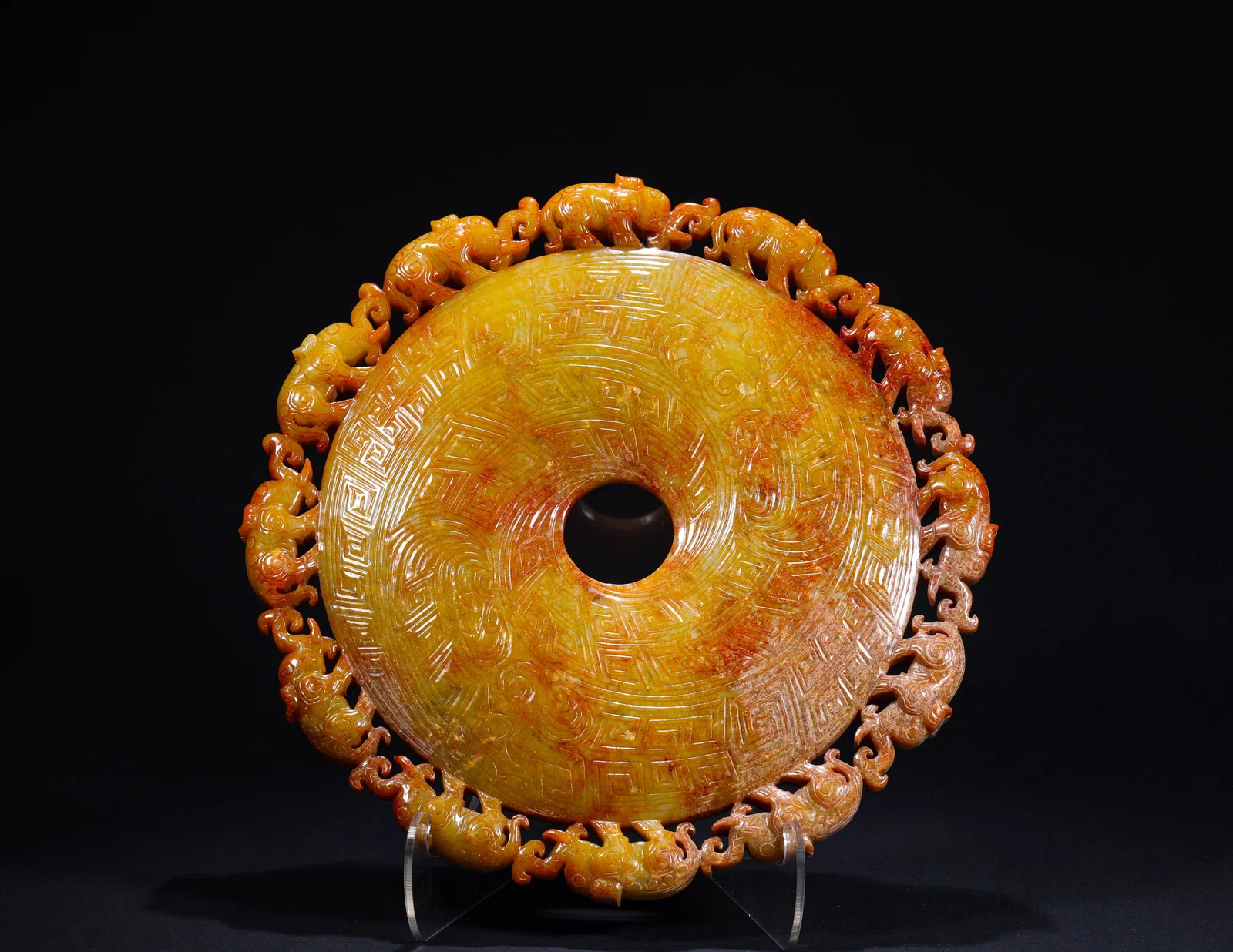 AN ANCIENT HAN DYNASTY JADE DISC WITH A PATTERN OF AUSPICIOUS BEASTS