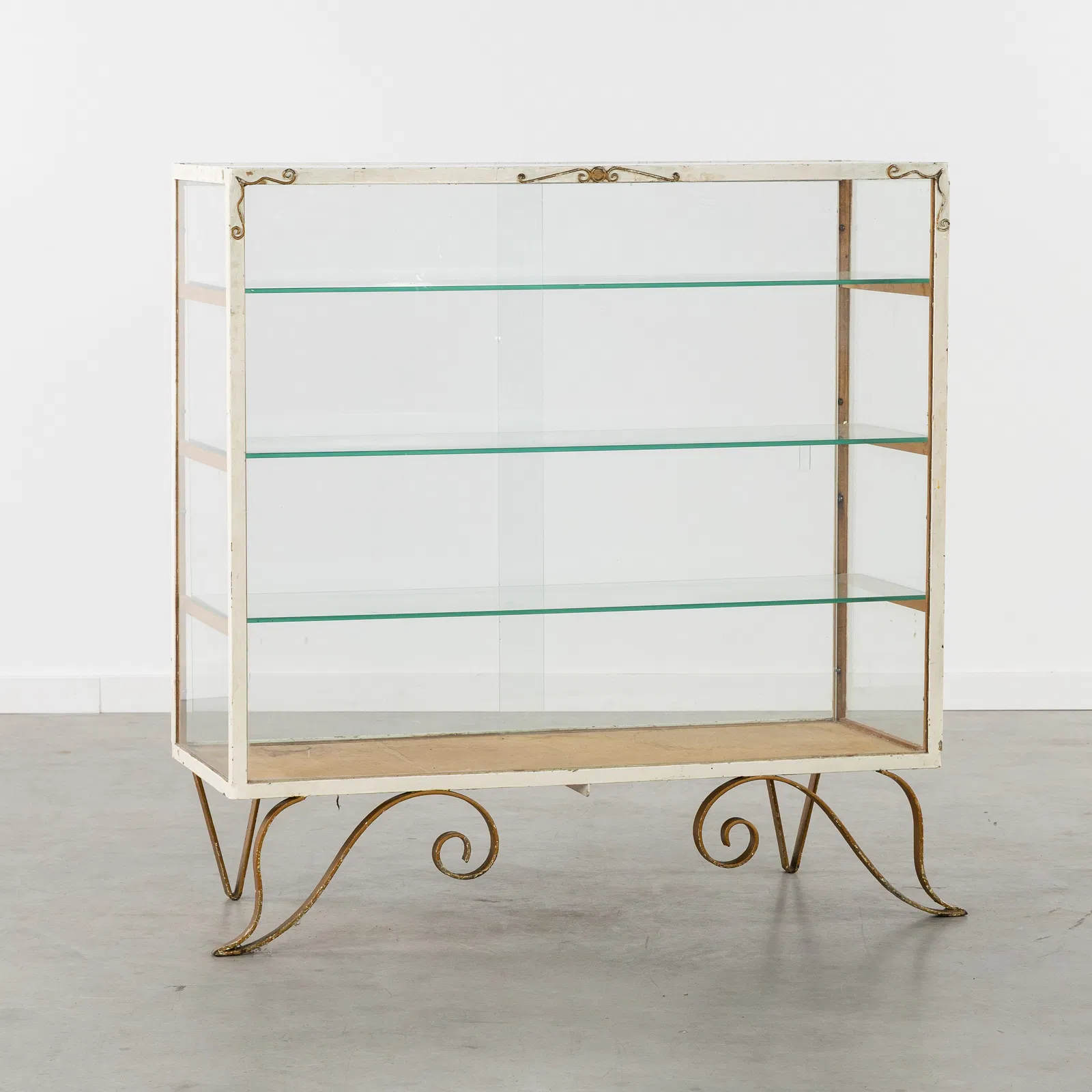 An Antique display cabinet or shop counter, patinated metal and glass, circa 1930-1940.