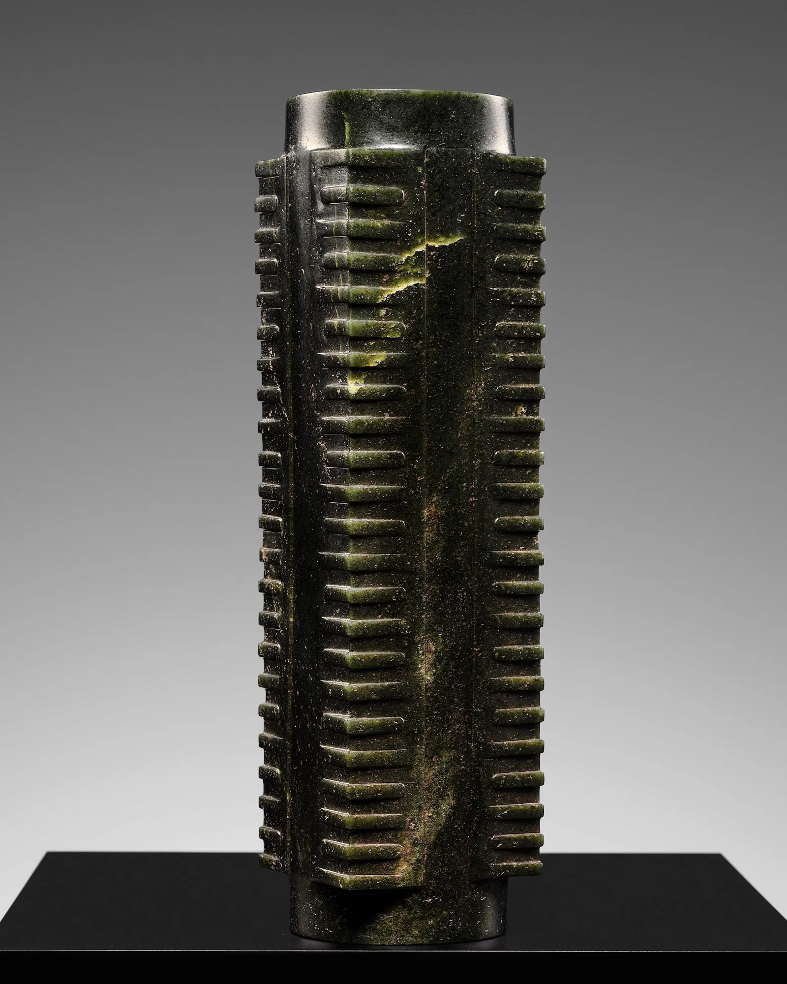 AN EXCEEDINGLY RARE ELEVEN-TIERED DARK GREEN JADE CONG, LIANGZHU CULTURE