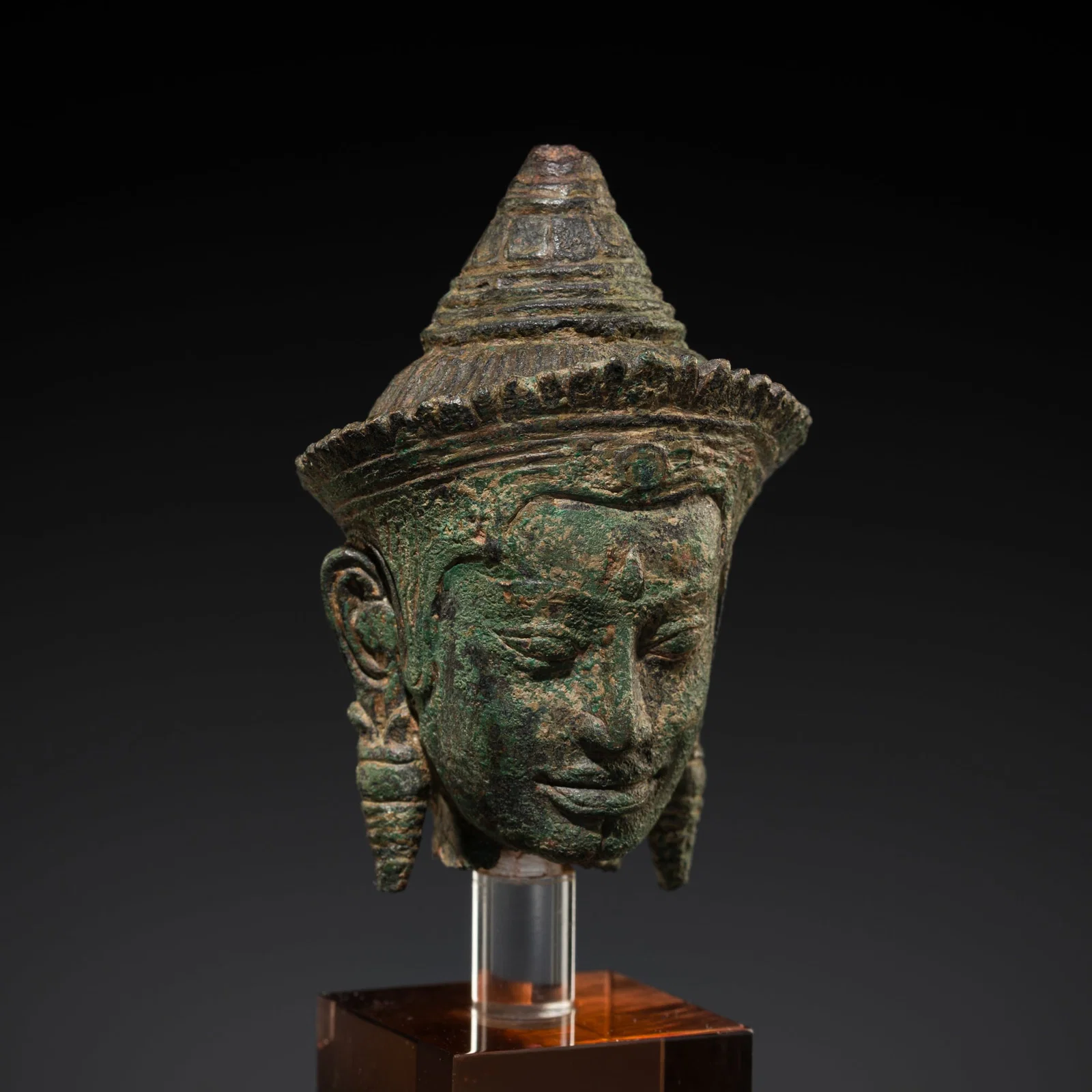 AN EXPRESSIVE BRONZE HEAD OF A DEITY, ANGKOR PERIOD, BAYON STYLE, 12TH-13TH CENTURY