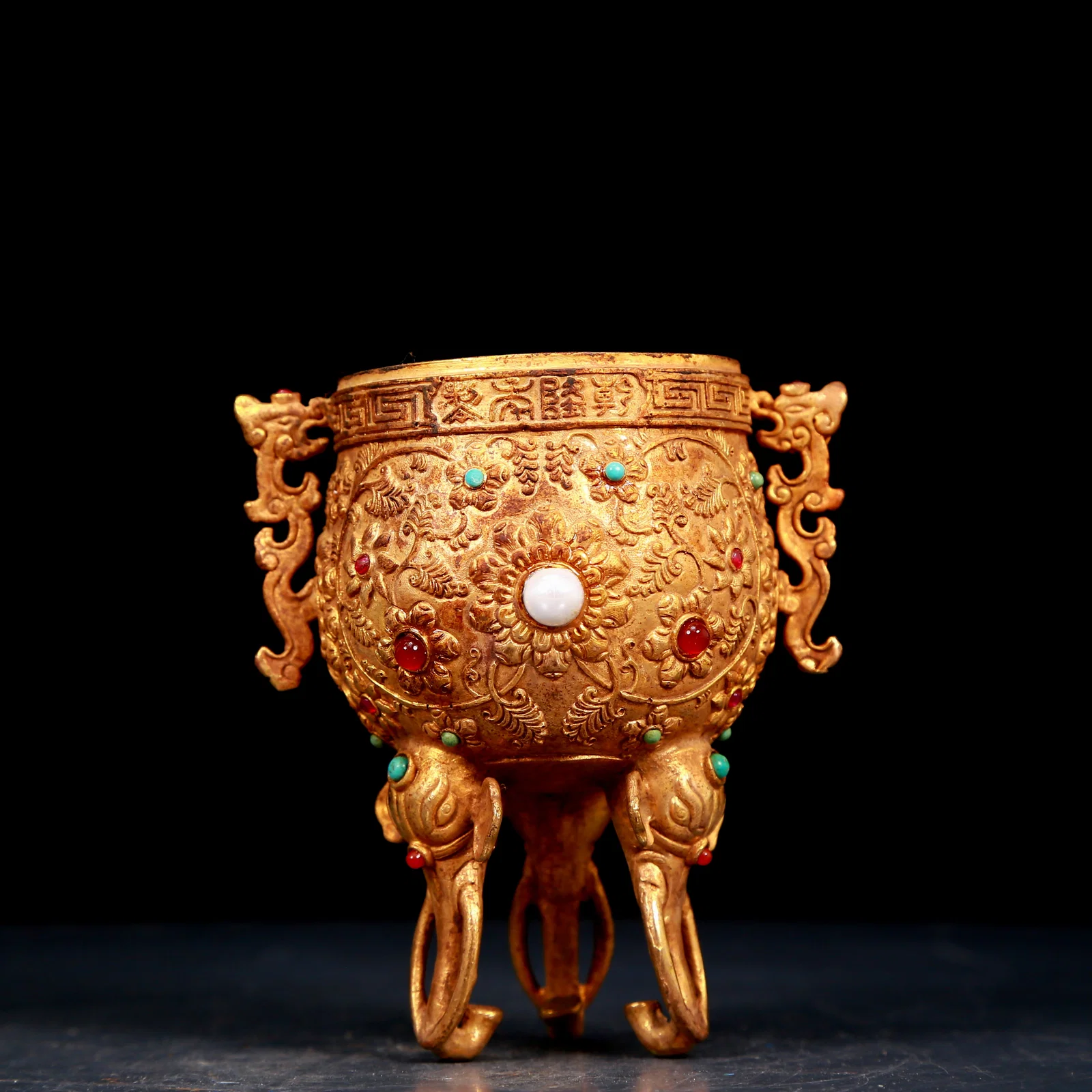 An exquisite gilt bronze cup with double ears, tripod and dragon pattern inlaid with gems