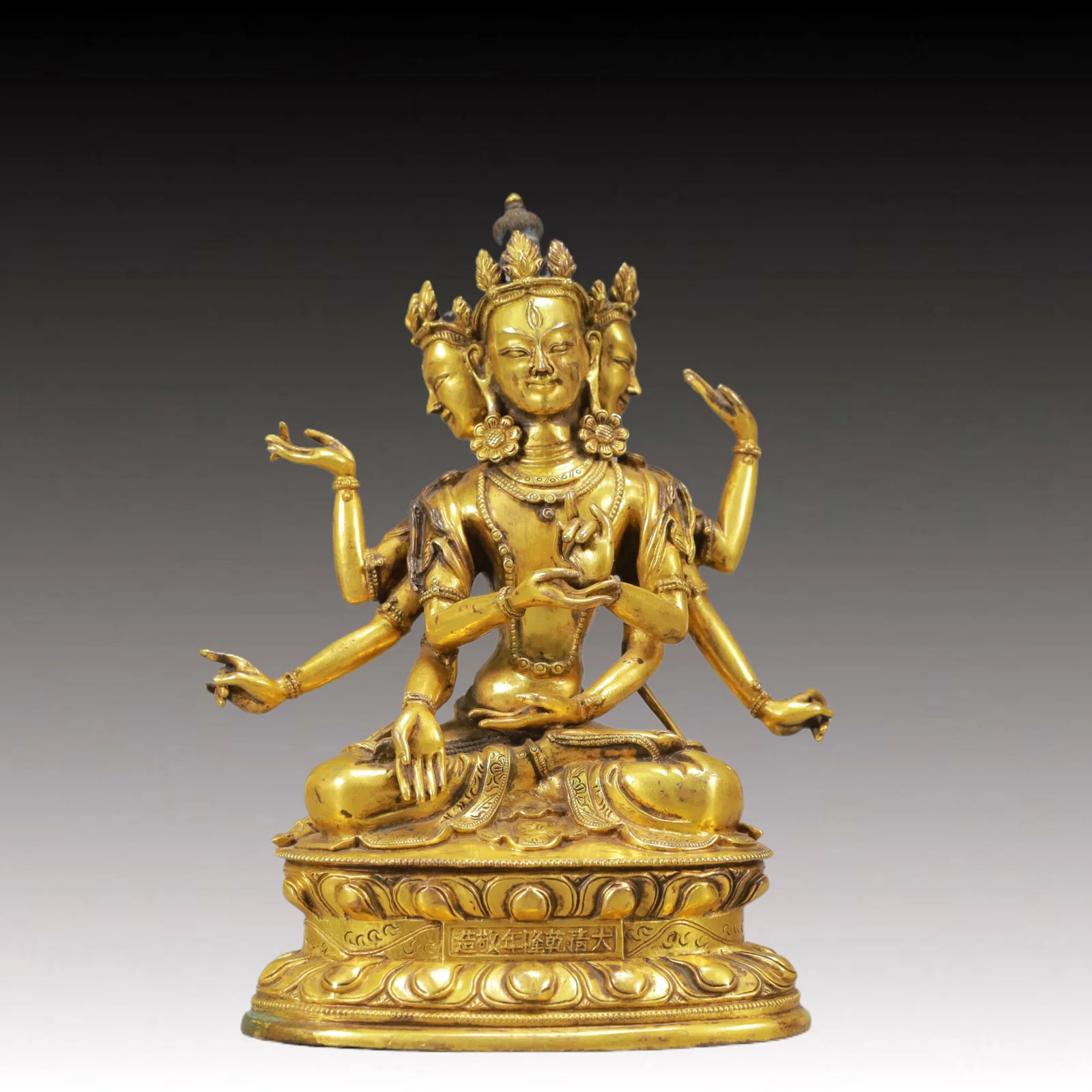 An Exquisite Gilt Bronze Three-Headed and Eight-Armed Guanyin