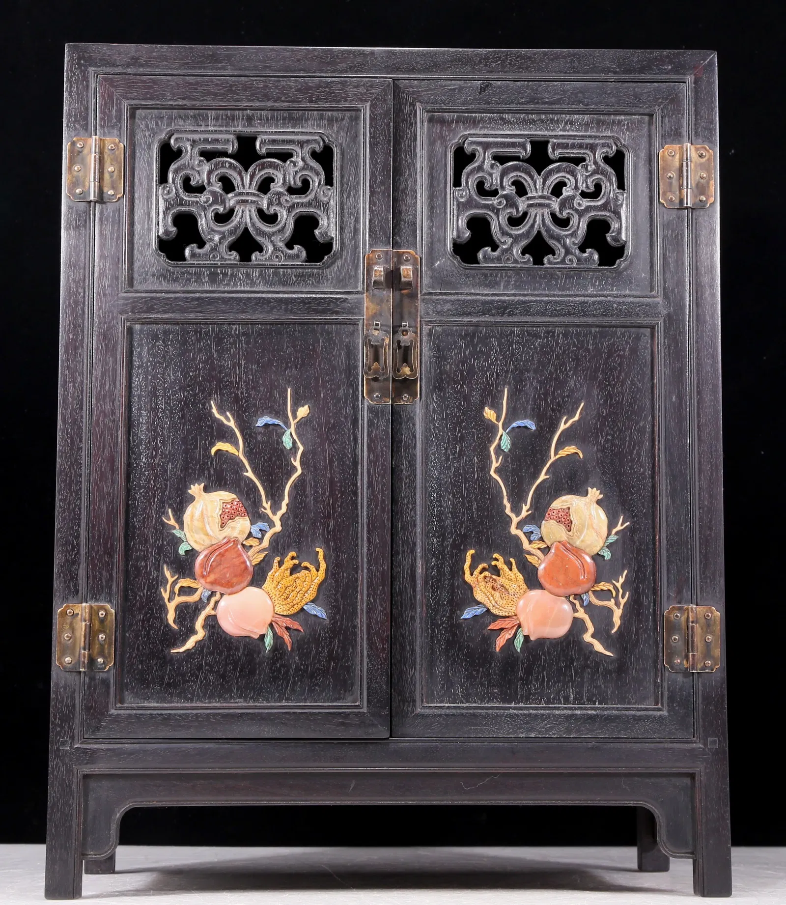An exquisite zitanwood cabinet inlaid with gems and patterns of fortune, wealth, longevity and