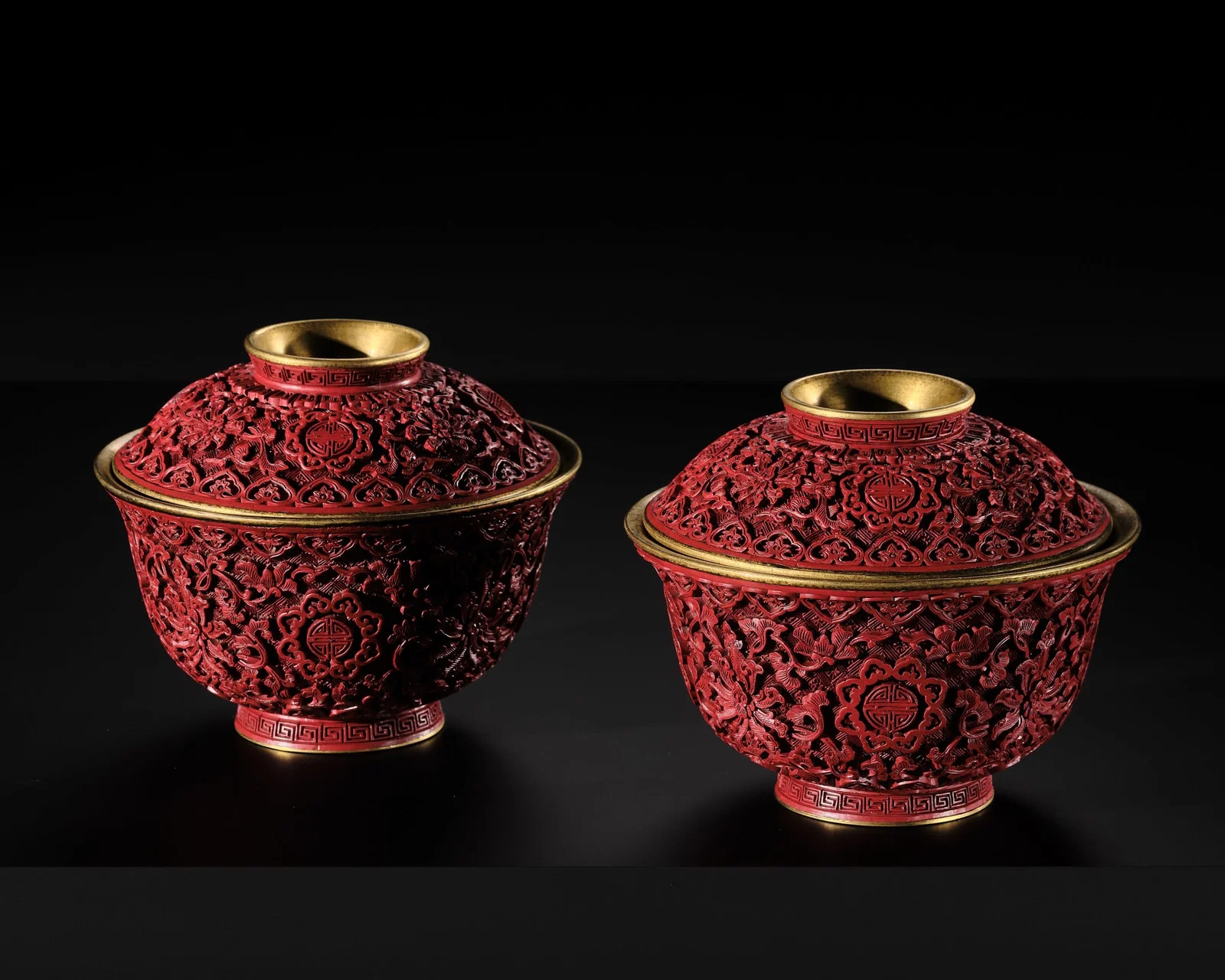 AN EXTREMELY RARE PAIR OF RICHLY GILT IMPERIAL BRONZE AND CINNABAR LACQUER 'SHOU' BOWLS AND COVERS,
