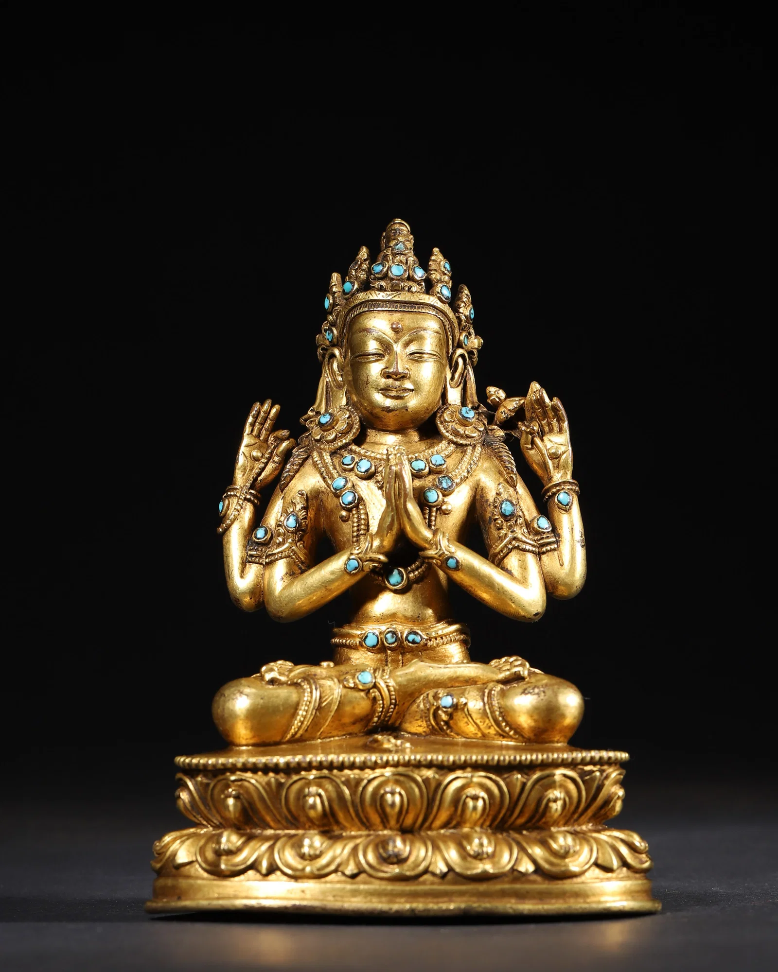 AN GILT-BRONZE FIGURE OF FOUR-ARMED AVALOKITESHVARA INLAID WITH TURQUOISE, MING DYNASTY