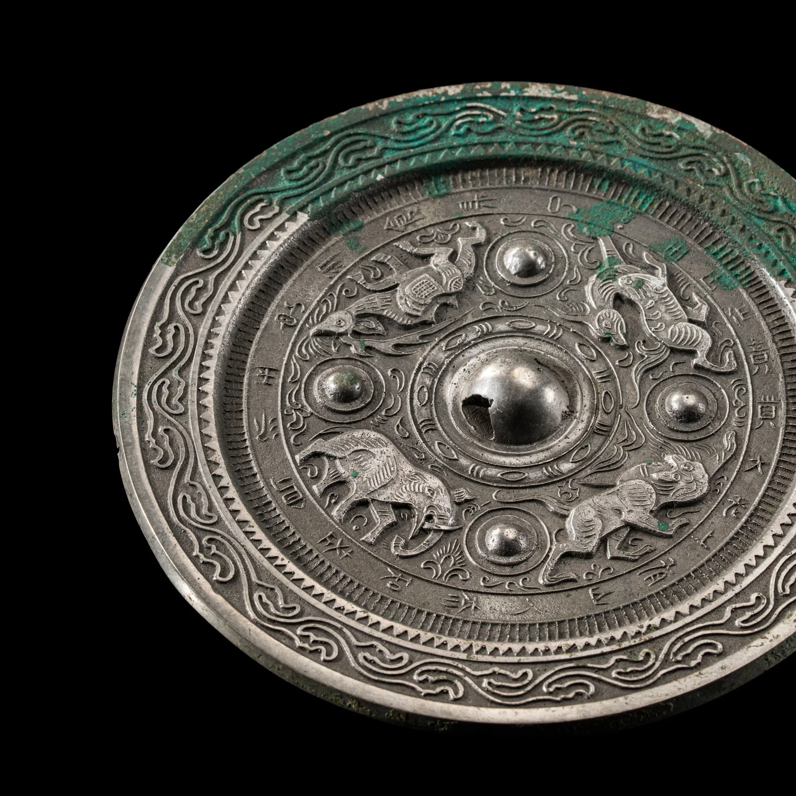AN INSCRIBED SILVERED BRONZE 'BEASTS AND ANIMALS' MIRROR, EASTERN HAN DYNASTY