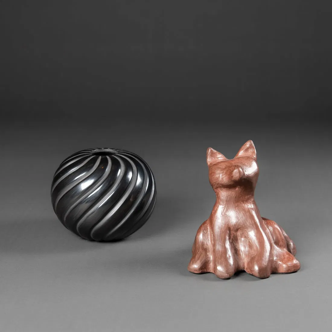 An Isleta Pueblo pottery fox and Santa Clara jar