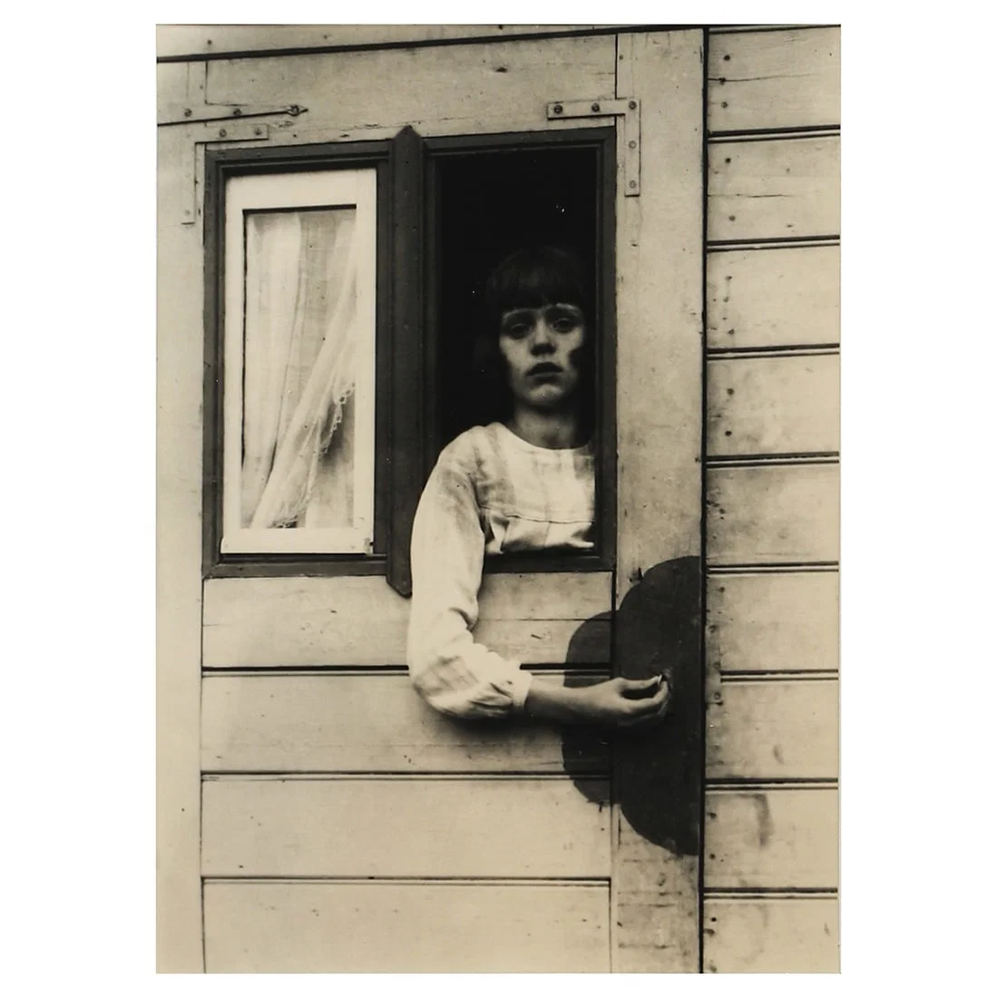 AUGUST SANDER (1876–1964), GIRL IN FAIRGROUND CARAVAN