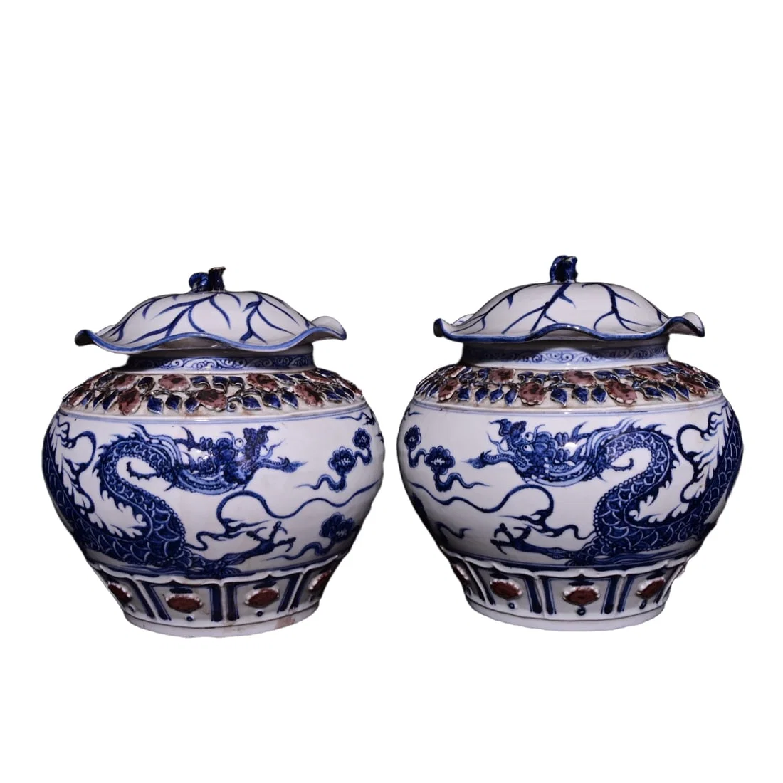 Blue and white glazed jar with red dragon design and lotus leaf lid.