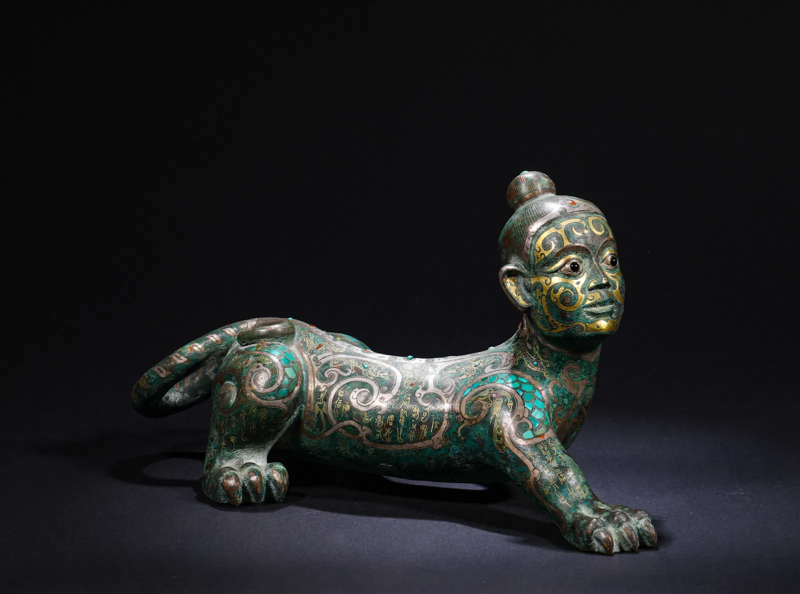 BRONZE PENDANT WITH INLAID GOLD AND SILVER INLAID WITH GEMSTONES AND HUMAN FACE AND ANIMAL BODY FROM