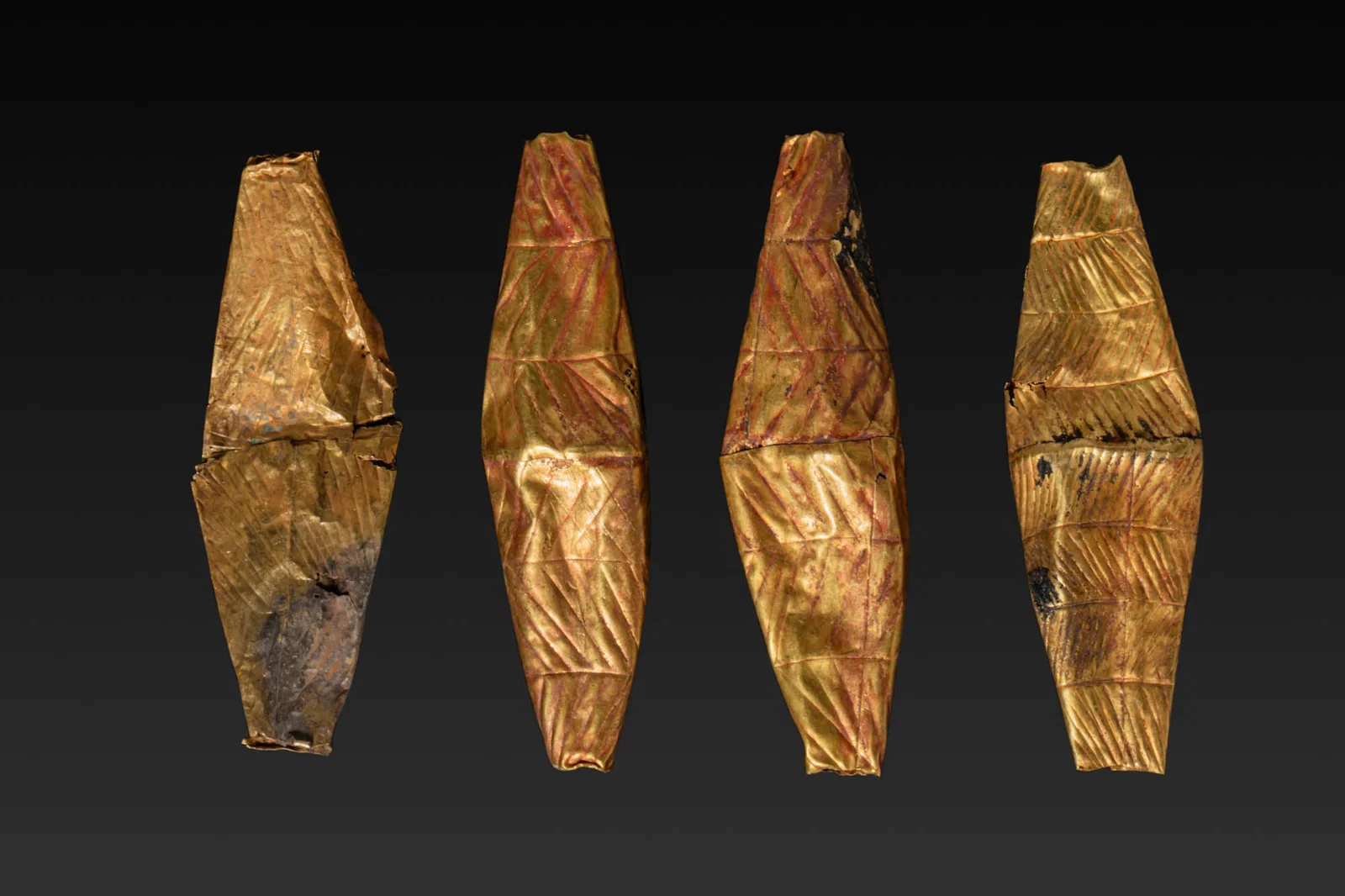 COLLECTION OF FOUR LARGE GREEK GEOMETRIC HIGH KARAT GOLD BICONICAL BEADS WITH ENGRAVED MOTIFS