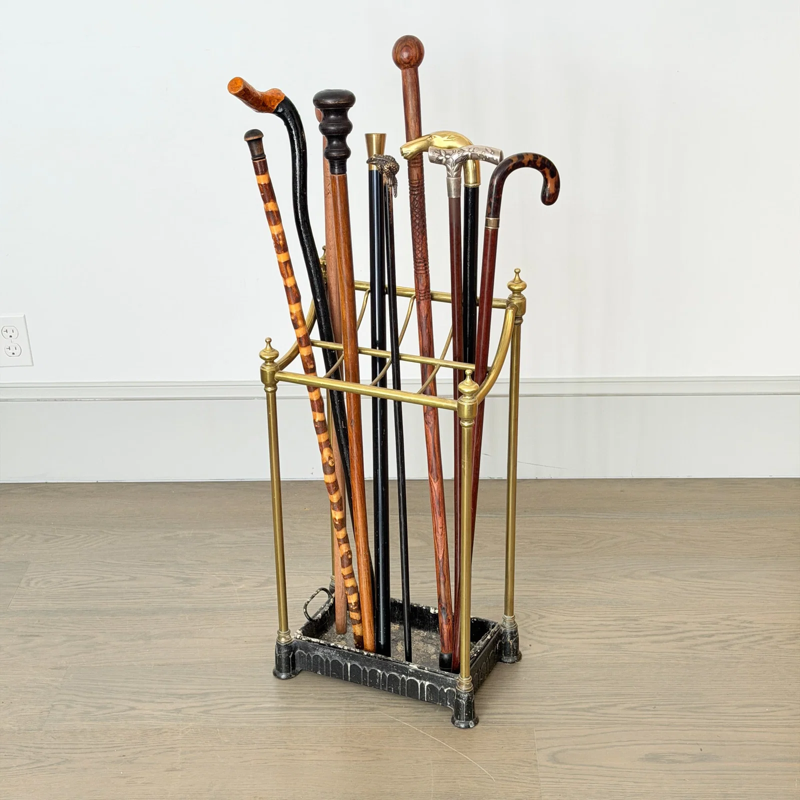 Group of Canes and Walking Sticks in a Brass and Iron Stand