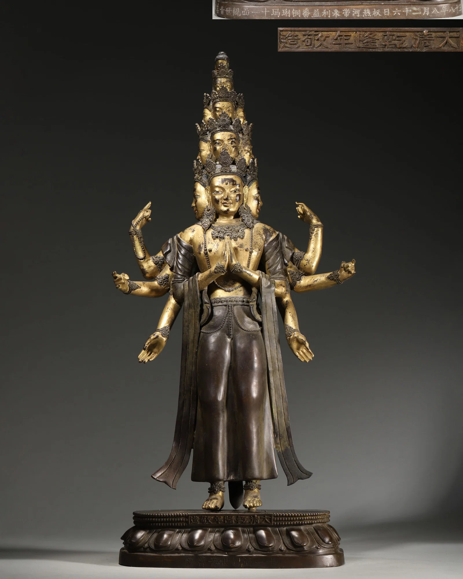 IMPERIAL QIANLONG PERIOD, QING DYNASTY GILT-BRONZE STANDING STATUE OF ELEVEN-FACED AVALOKITESHVARA