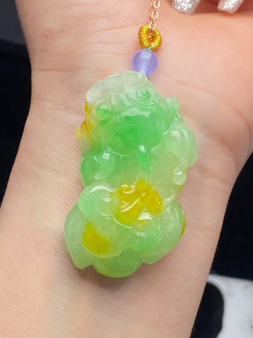 Jadeite "Pixiu" pendant, made of glutinous yellow jade with floating green color.