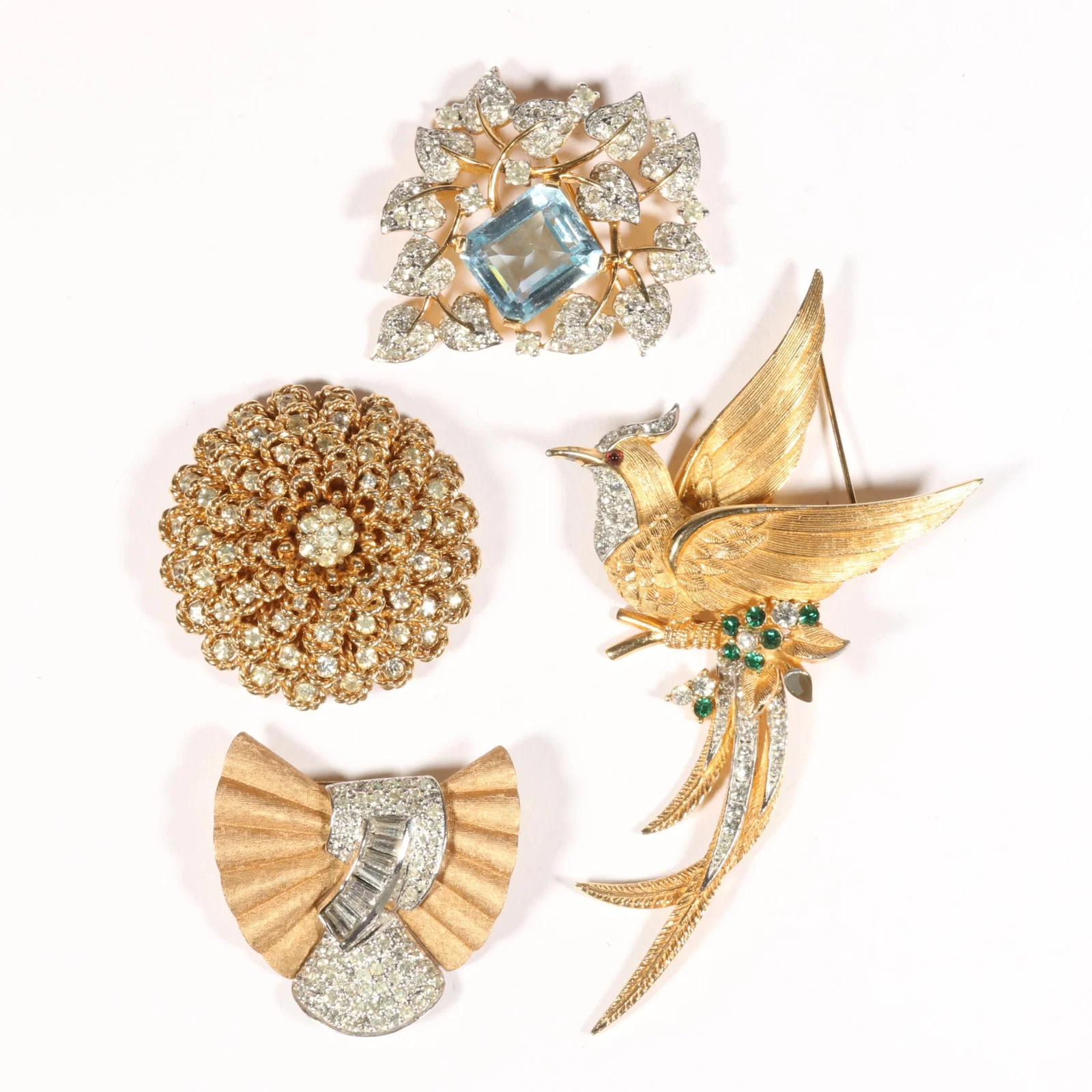 Jomaz, Boucher, and Pennino 4pc brooch group: Jomaz brooch with large aquamarine glass jewel and