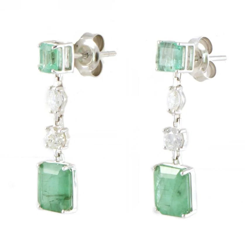 Long earrings with emeralds and diamonds.