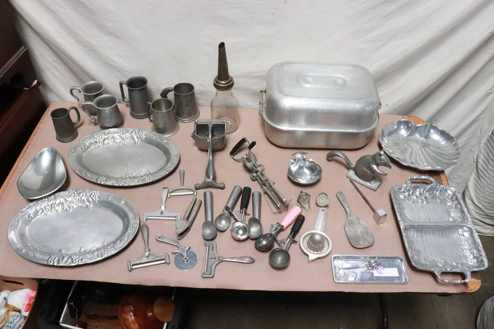 lot of aluminum kitchen items, & a glass oil bottle