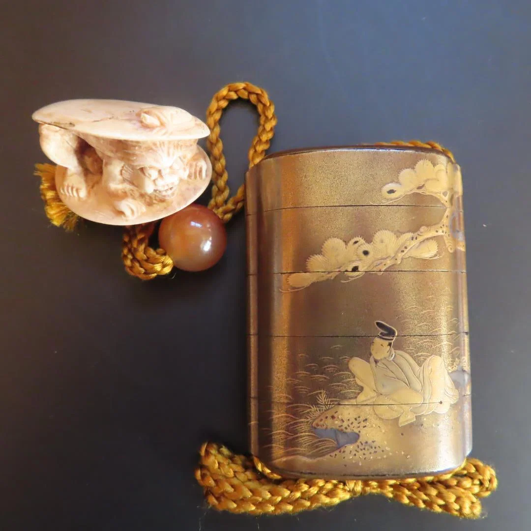 Maki-e inrO (small decorative container) with netsuke, featuring a design of pine trees, an elderly