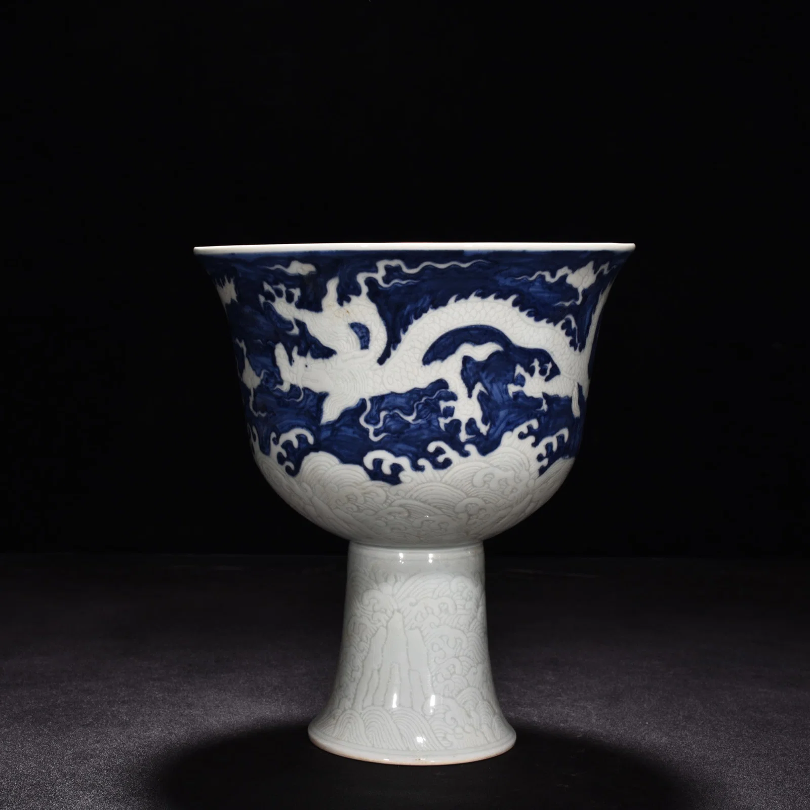 Ming Dynasty Xuande blue and white engraved sea water dragon red glaze tall bowl