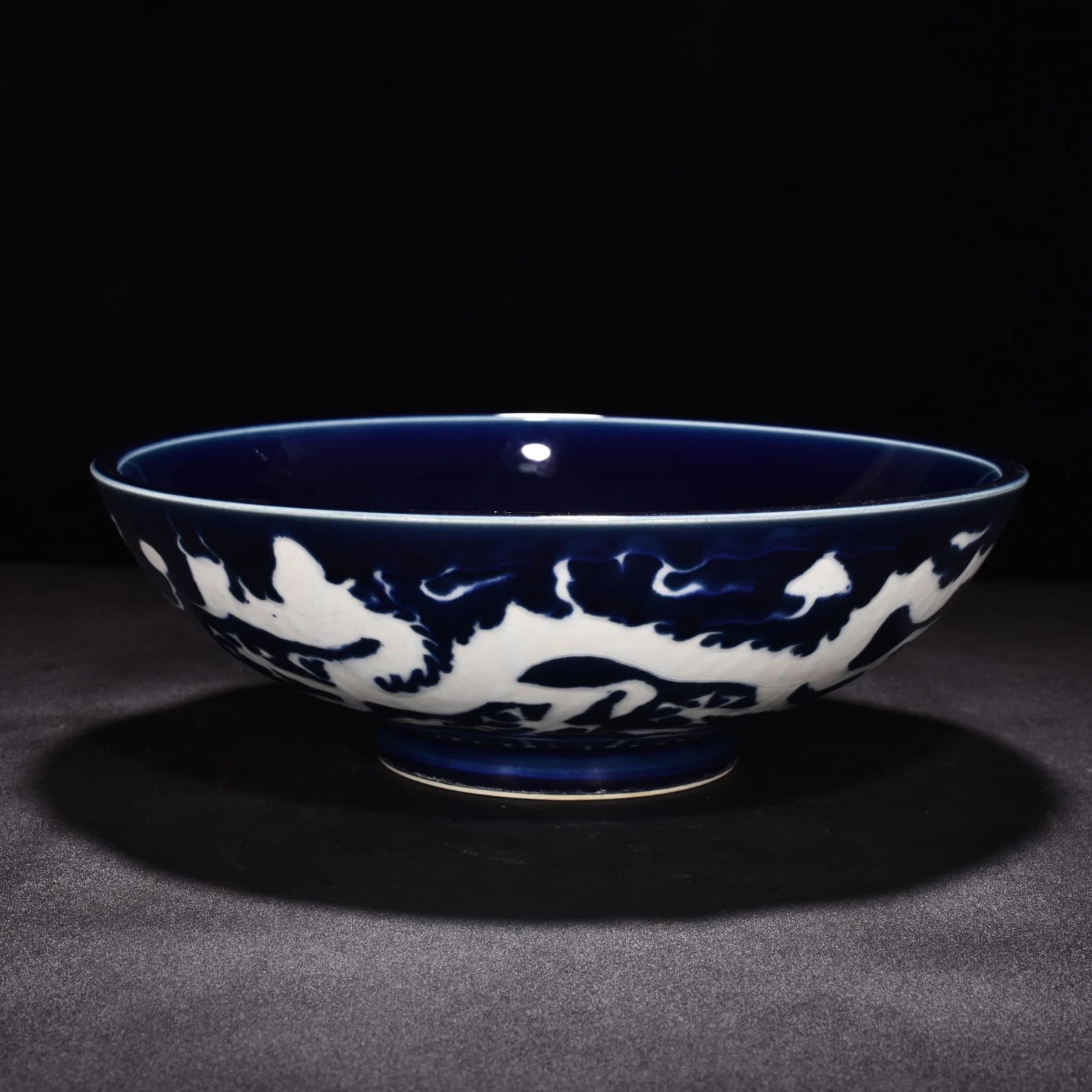 Ming Dynasty Xuande sapphire blue glaze with white engraved double dragon dice bowl