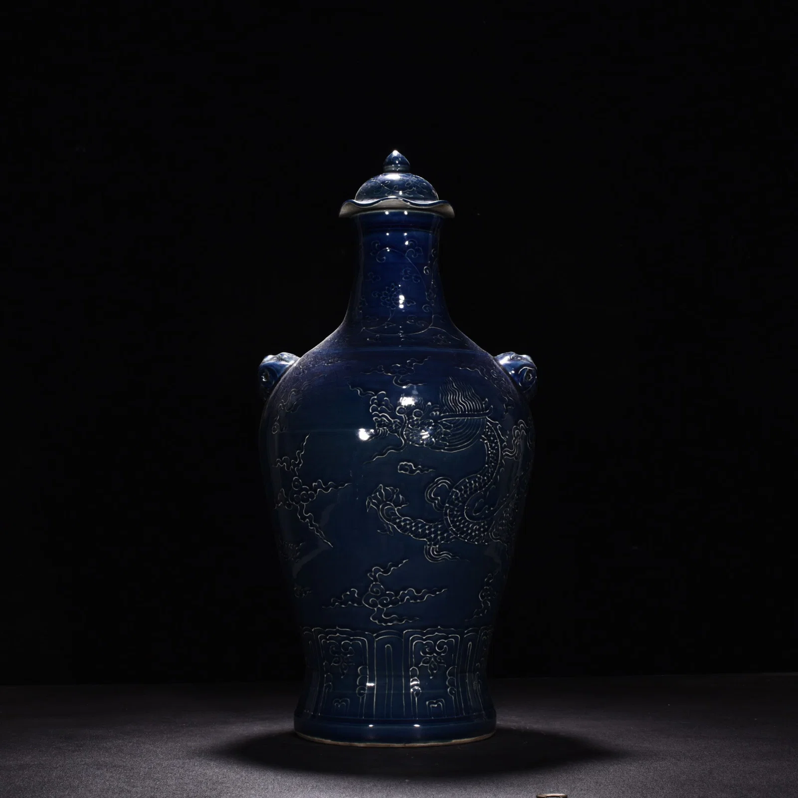 Ming Dynasty Yongle Ji blue glaze carved cloud and dragon animal ear capped bottle