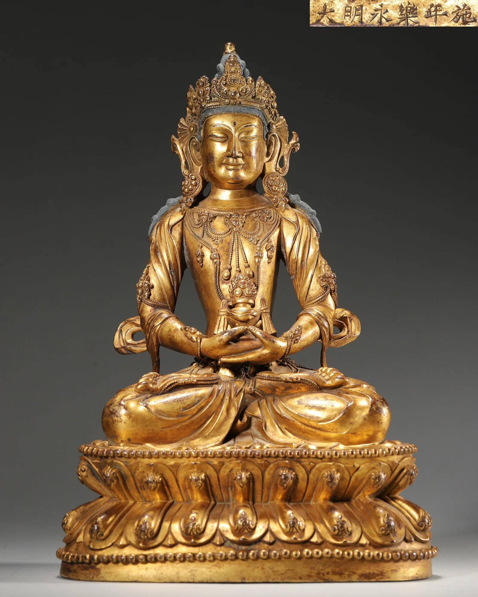 MING DYNASTY, YONGLE PERIOD, IMPERIAL COURT-MADE, GILT-BRONZE SEATED AMITAYUS BUDDHA STATUE