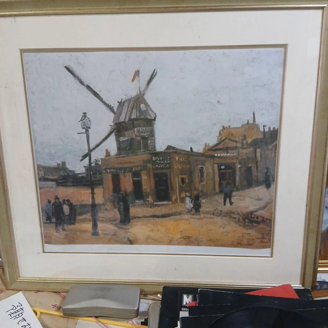 Oil painting of a windmill with a golden frame by Gogh.