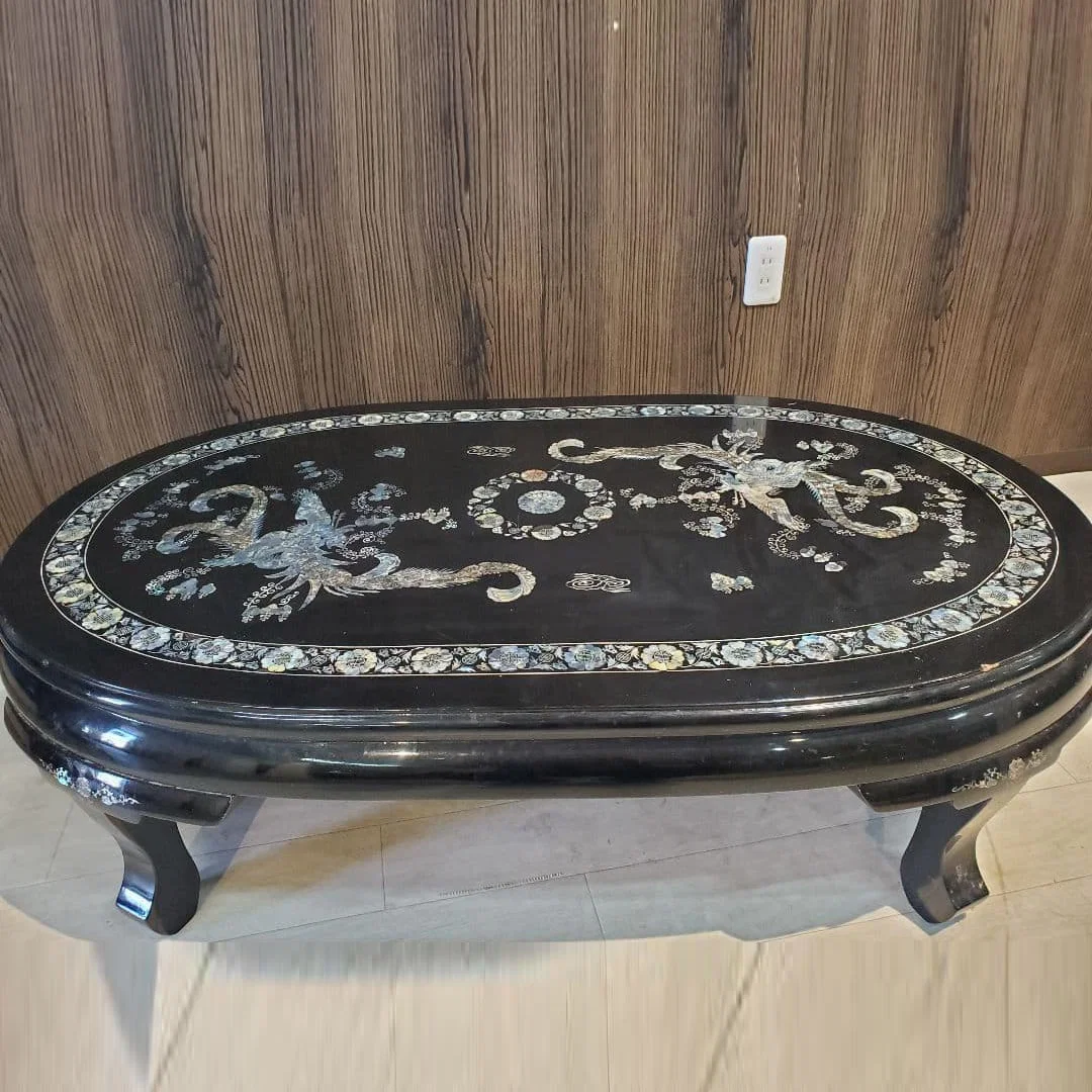 Oval wooden table in Asian style.