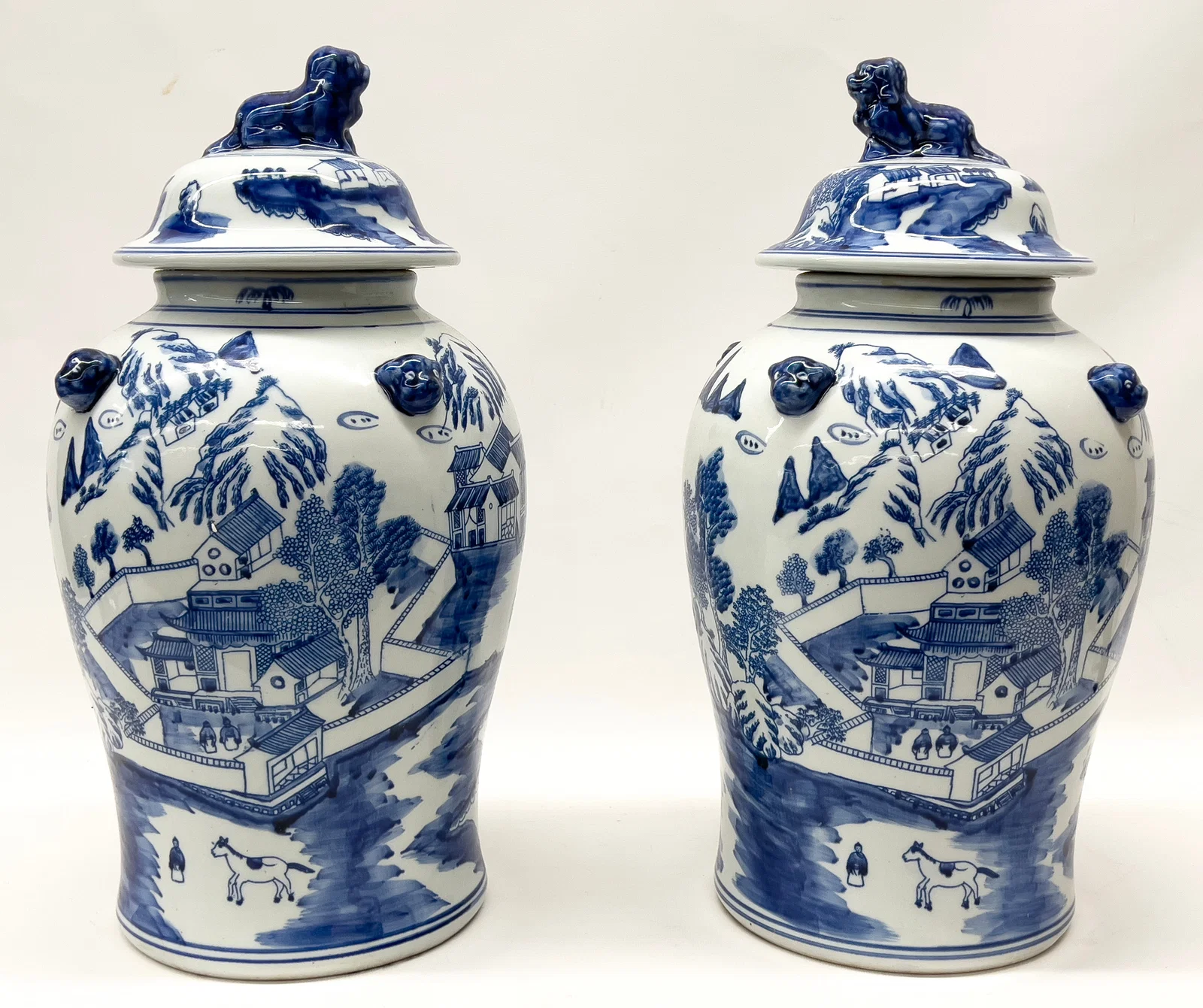 PAIR OF CHINESE BLUE AND WHITE PORCELAIN COVERED URNS