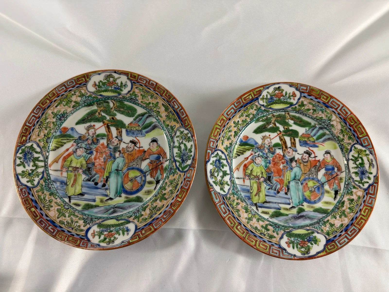 Pair of Chinese enameled famille rose scene porcelain plates