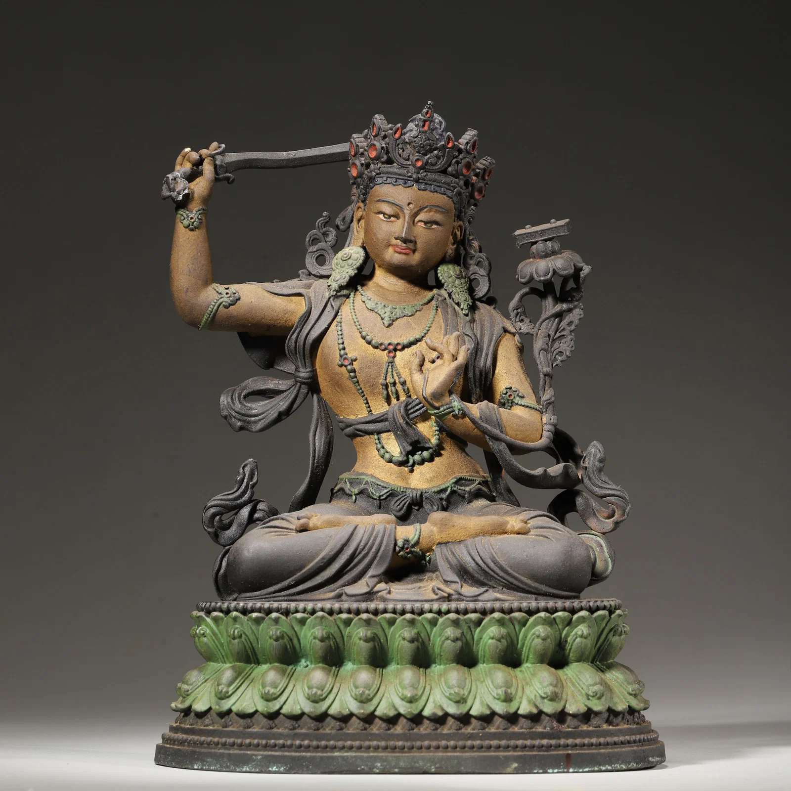QING DYNASTY BRONZE PAINTED AND GILDED MANJUSHRI BODHISATTVA STATUE