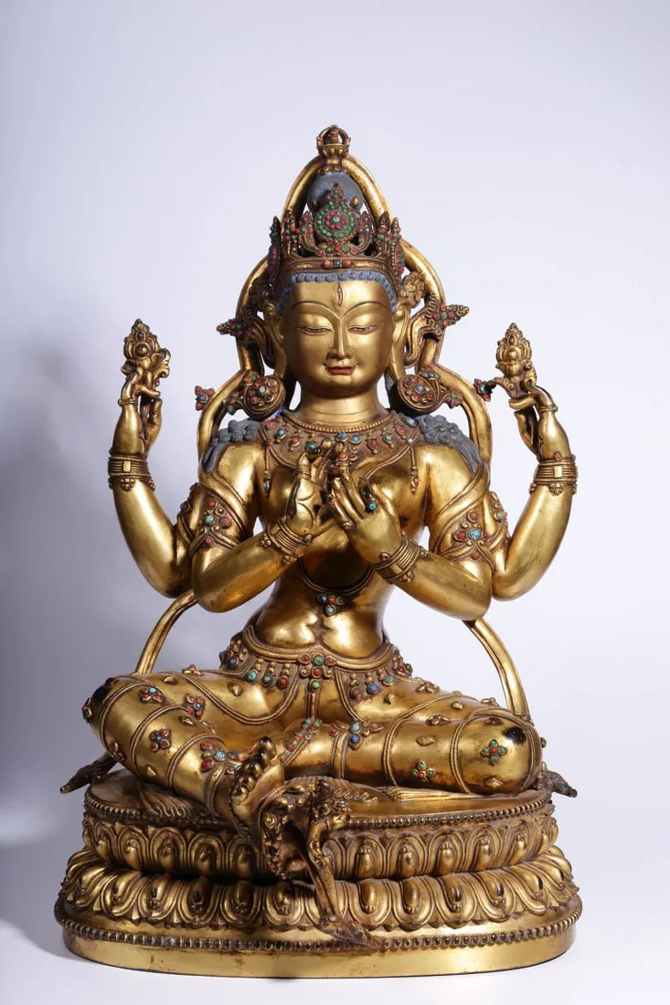 QING DYNASTY, DENSATIL MONASTERY STYLE GILT BRONZE INLAID GEMSTONE FOUR-ARMED GUANYIN STATUE