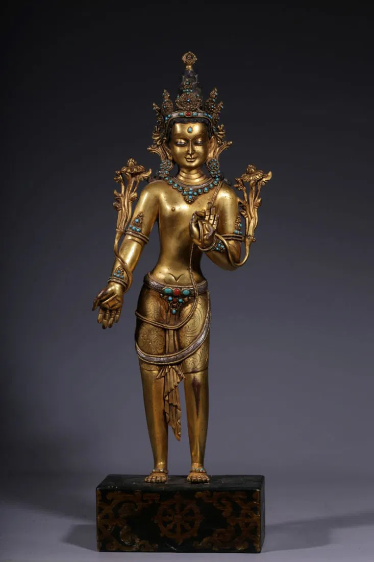 QING DYNASTY, GILT BRONZE INLAID GEMSTONE STANDING GUANYIN HOLDING LOTUS