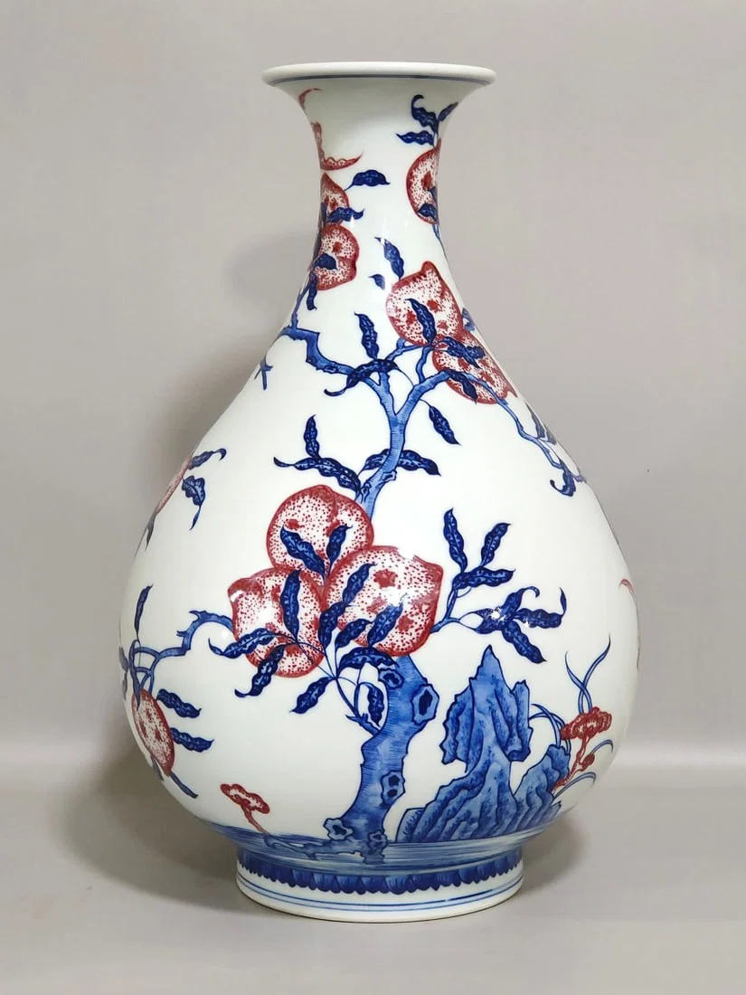 Qing Dynasty Qianlong blue and white underglaze red Five Blessings and Nine Peach spring vase
