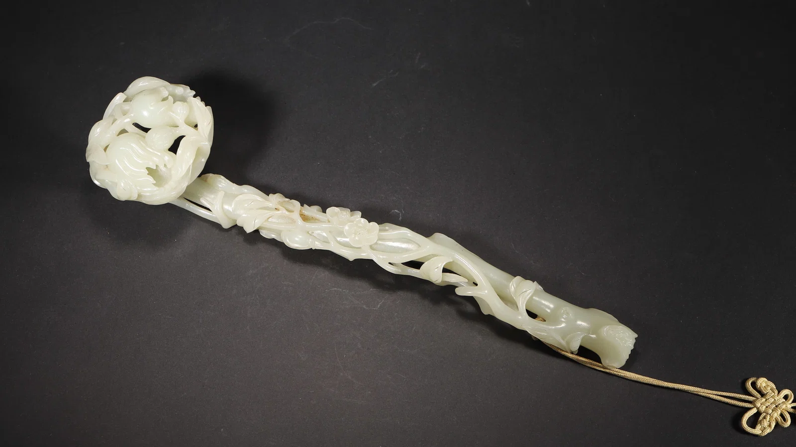 QING DYNASTY, WHITE HETIAN JADE OPENWORK RUYI WITH BUDDHA'S HAND AND FLORAL MOTIFS