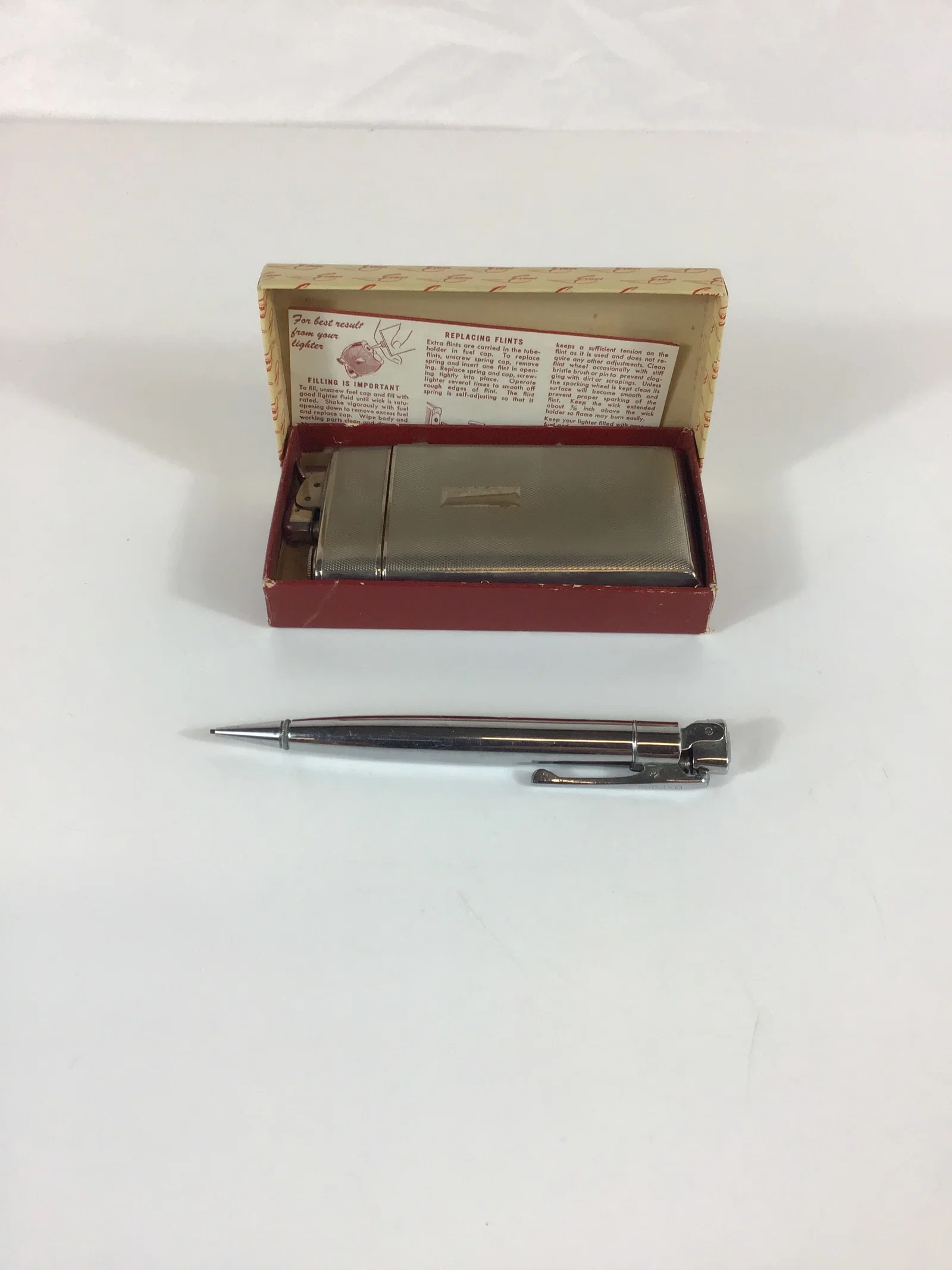 Two Vintage Personal Accessories Including an Evans Lighter and Case Combo and an Oxford Lighter