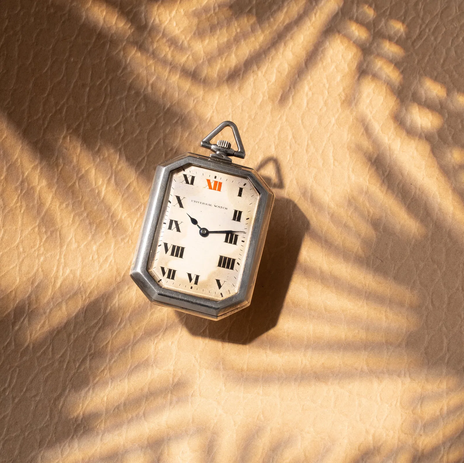 UNIVERSAL WATCH MANUAL-WINDING OCTAGONAL SILVER POCKET WATCH WITH WHITE DIAL